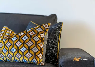 two pillows sitting on top of a couch at 2 Bed Sleeps 4 with Private Parking in Airdrie in Airdrie