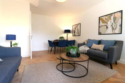 a living room with a couch and a table at Signature - Oak House in Coatbridge