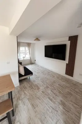 a living room with a flat screen tv on a wall at 3BR Detached Home, Driveway & Large Rear Garden in Hogganfield