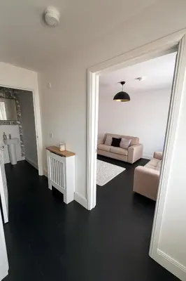 a living room with a couch and a table at 3BR Detached Home, Driveway & Large Rear Garden in Hogganfield