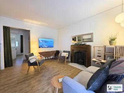 a living room with a couch and a fireplace at High Street Stay - Oban in Oban