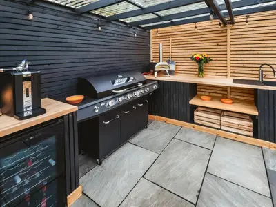 an outdoor kitchen with a stove and a sink at Arran - Uk48415 in Dalry