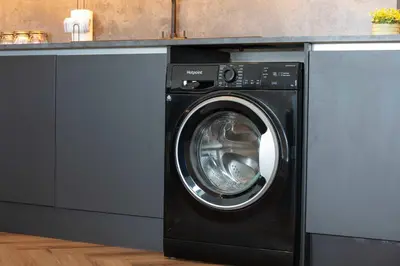a black washer and dryer under a counter at Weaver Suite - Donnini Apartments in Ayr