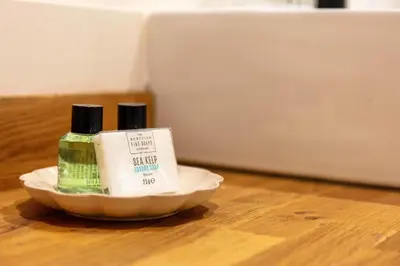 two bottles of soap in a bowl on a table at Weaver Suite - Donnini Apartments in Ayr