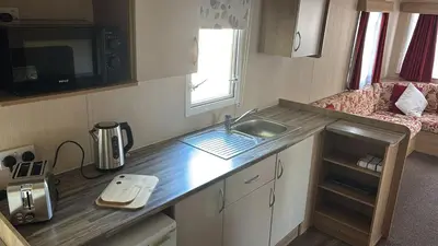 a small kitchen with a sink in a caravan at Plot 3 ABI Horizon in Moffat