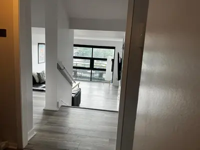 a hallway with a view of a living room at City Centre Apartment in Glasgow