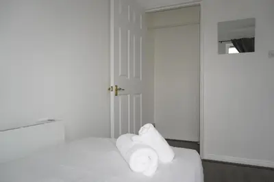 a white room with towels sitting on a bed at Glasgow Riverview Apartment in Glasgow