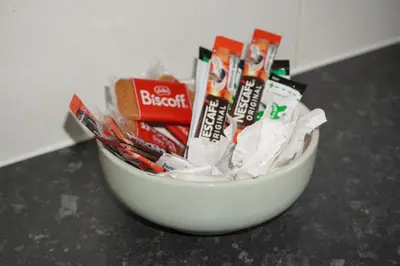 a white bowl filled with toothbrushes and toothpaste at Glasgow Riverview Apartment in Glasgow