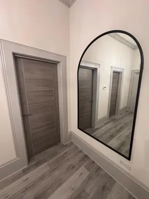 a large mirror in a room with two doors at Taobh na Mara - Macaulay Letting in Helensburgh
