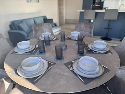 a table with plates and utensils on top of it at Taobh na Mara - Macaulay Letting in Helensburgh