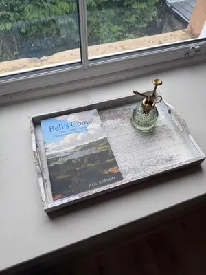 a magazine sitting on a window sill with a vase at The Comet - Macaulay Letting in Helensburgh