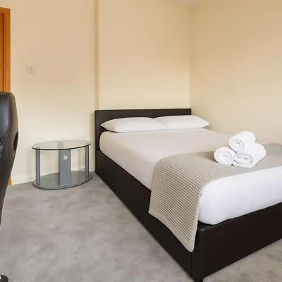 a hotel room with two beds with towels on them at Bright & Spacious 2 Bedroom Flat in Edinburgh