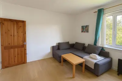 a living room with a couch and a table at Bright & Spacious 2 Bedroom Flat in Edinburgh