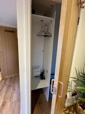 a room with a closet with a shelf at Stylish Cabin with Countryside Views and King Bed in Maybole