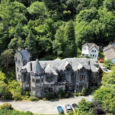 an old mansion with cars parked in front of it at A Baronial Hall apartment - great views of Loch Fyne