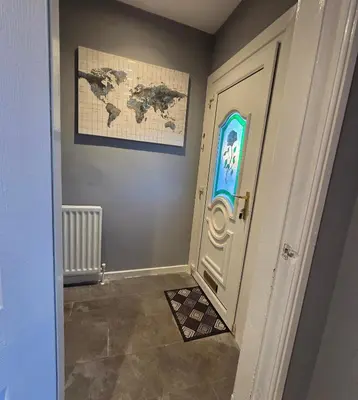 a room with a door with a world map on the wall at 3 Bedroom FM Homes & Apartments Wishaw Motherwell in Dalziel