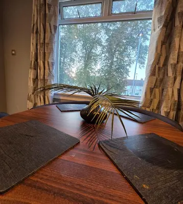 a wooden table with a plant on top of it at 3 Bedroom FM Homes & Apartments Wishaw Motherwell in Dalziel