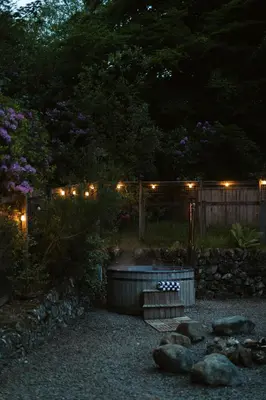 a garden at night with lights on a fence at The Coach House in Castle Douglas