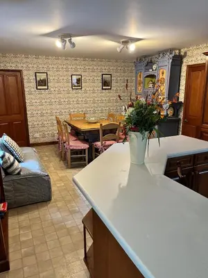 a kitchen and dining room with a table with a vase of flowers at Glenogle Highland Estate Home in Lochearnhead