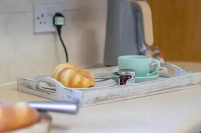 a tray with a loaf of bread on a counter at Ashgrove House - 3 bedroom in Coatbridge