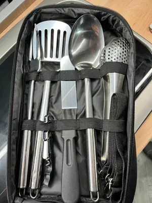 a suitcase filled with utensils sitting on a counter at Campervan Scotland, Glen Roamer in Braco
