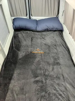 a bed in the back of a camper van at Campervan Scotland, Glen Roamer in Braco