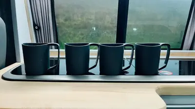 a tray with four coffee mugs on a window sill at Campervan Scotland, Glen Roamer in Braco