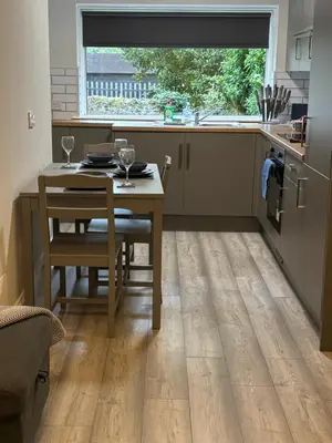 a kitchen with a table and a table and a window at Seaside Escape 101 Nelson Largs in Largs