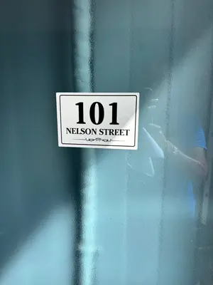 a sign on the side of a door that says liaison street at Seaside Escape 101 Nelson Largs in Largs