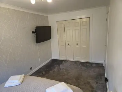 a bedroom with a bed and a tv on the wall at Seafield Crt, North Shore Beach in Horse Isle