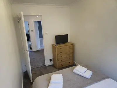 a bedroom with a bed and a television on a dresser at Seafield Crt, North Shore Beach in Horse Isle