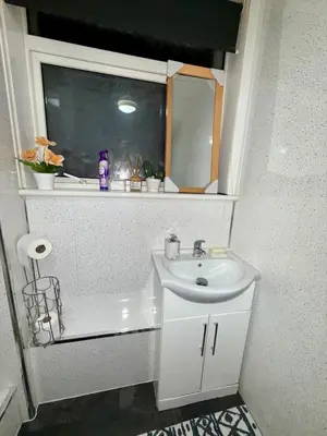 a small bathroom with a sink and a mirror at Likewise Modern Two bedrooms Home for 4 in Glasgow Area in Pollokshaws
