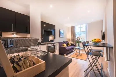 a kitchen and living room with a counter top at Braid Apartments by Mansley in Edinburgh