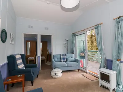 a living room with blue furniture and a sliding glass door at Scarba in Oban