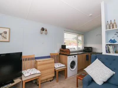 a living room with a tv and a washing machine at Scarba in Oban