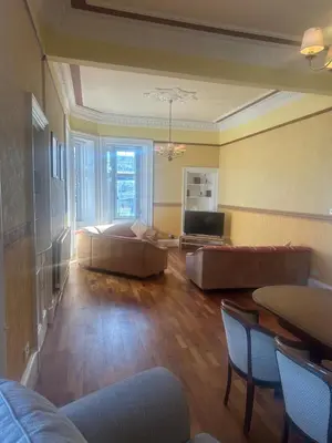 a large living room with a bed and a table at Crawford House in Largs