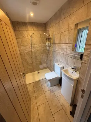 a bathroom with a toilet and a sink and a shower at Balnakeil house
