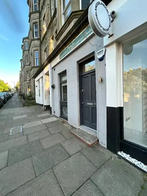 a building with a clock on the side of it at Fantastic 1 Bed in Heart of Edinburgh in Edinburgh