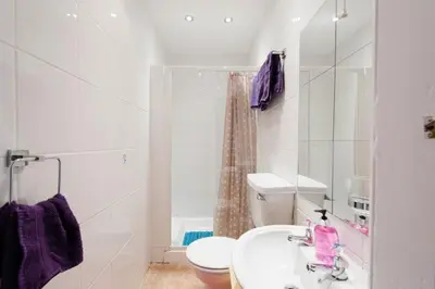 a white bathroom with a sink and a toilet at Edinburgh Central Lauriston Large Apartment in Edinburgh