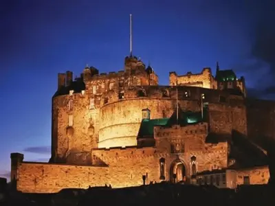 a large castle is lit up at night at Edinburgh Central Lauriston Large Apartment in Edinburgh