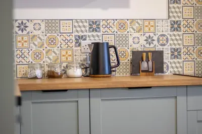 a kitchen counter with a coffee pot on top of it at Modern 2-Bed Apt, Private Parking, Ayr Town Centre in Ayr