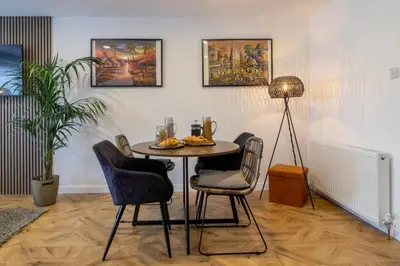 a dining room with a table and chairs at Modern 2-Bed Apt, Private Parking, Ayr Town Centre in Ayr