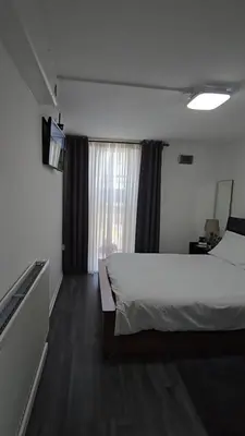 a hotel room with a bed and a television at Pazuri Apart in Moffat