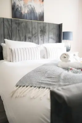 a bedroom with two beds with white pillows at Arranview Retreat in Airdrie