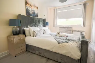 a bedroom with a large bed with a dog laying on it at Arranview Retreat in Airdrie