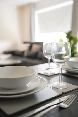 a table with plates and wine glasses on it at Arranview Retreat in Airdrie