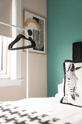 a bedroom with a bed with a zebra pillow and a picture at Beechgrove House in Livingston