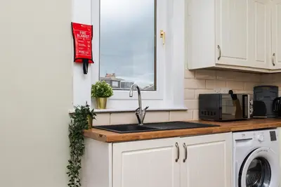 a kitchen counter with a sink and a window at 2Bed Upper Cottage-Street Parking-by Holiday Homes in Falkirk