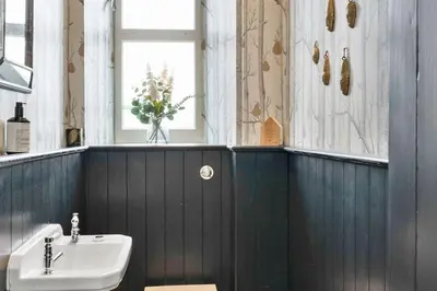 a bathroom with a sink and a vase of flowers at GuestReady - Elegant Edinburgh Retreat in Edinburgh
