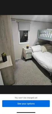 a picture of a bedroom with a bed and a window at Loch View 30 in Stranraer